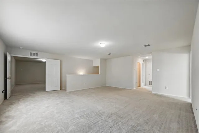a bathroom with a bathtub shower sink vanity mirror and toilet