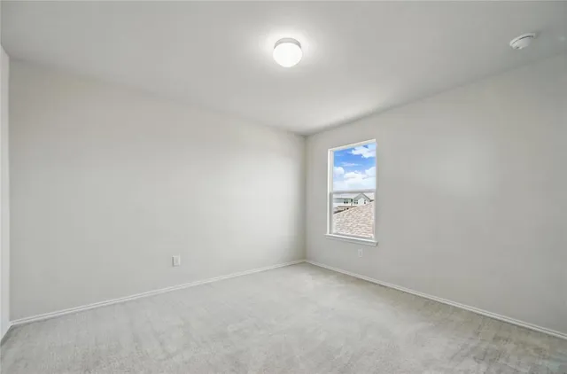 a view of a house with a yard and a large tree