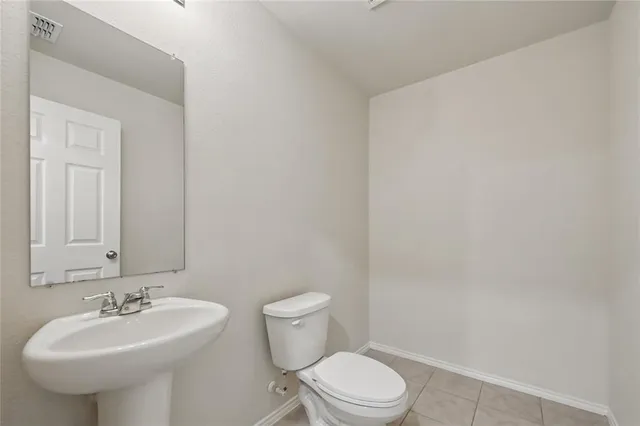 a bathroom with a sink a toilet and mirror