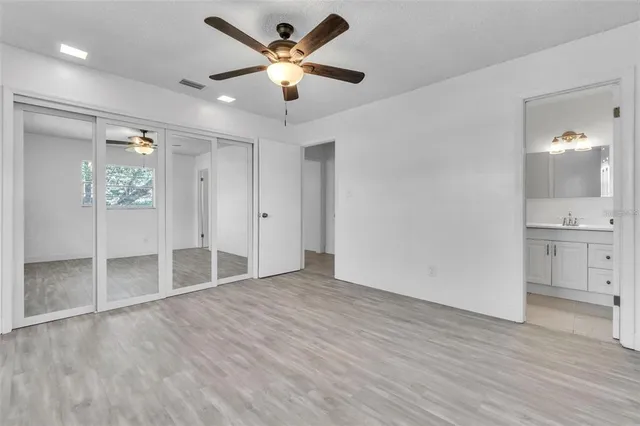 wooden floor in an empty room with a bathroom