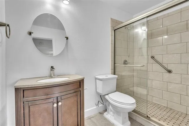 a bathroom with a toilet a sink and mirror