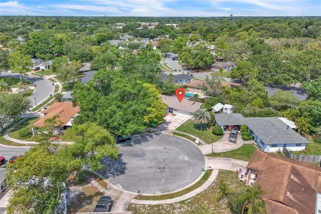 an aerial view of a house with a yard basket ball court and outdoor seating