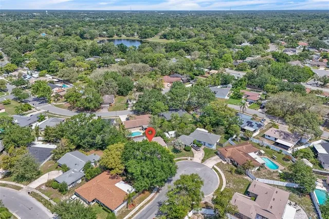 an aerial view of residential houses with outdoor space and street view