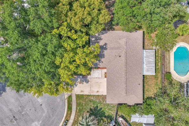 an aerial view of a house with a yard and garden