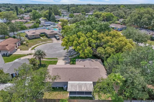 an aerial view of a house with a yard and lake view