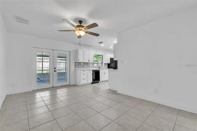 a view of kitchen with granite countertop cabinets and window