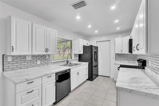 a kitchen with a sink stove and refrigerator