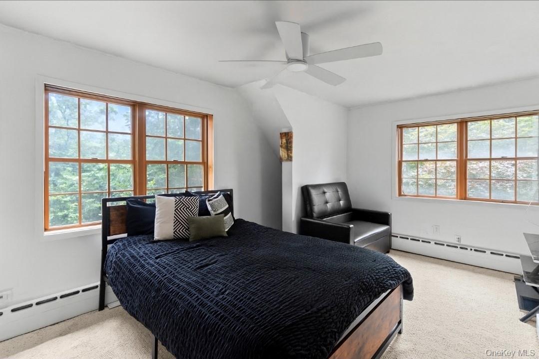 568 Old Liberty Road Monticello, NY 12701 - Photo 19 of 31 Bright and spacious Bedroom with a baseboard heating unit, carpet floors, and ceiling fan