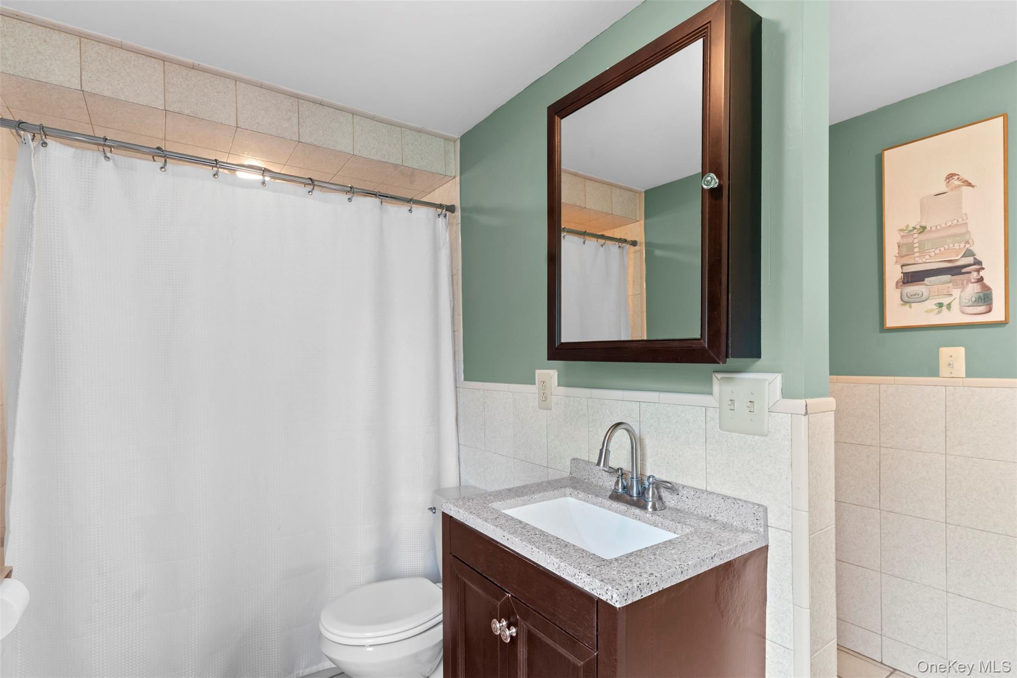 568 Old Liberty Road Monticello, NY 12701 - Photo 20 of 31 Bathroom featuring tile walls, vanity, and bath tub/shower combo