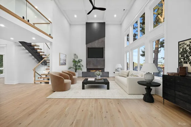 a view of living room with stainless steel appliances wooden floor dining table and chair