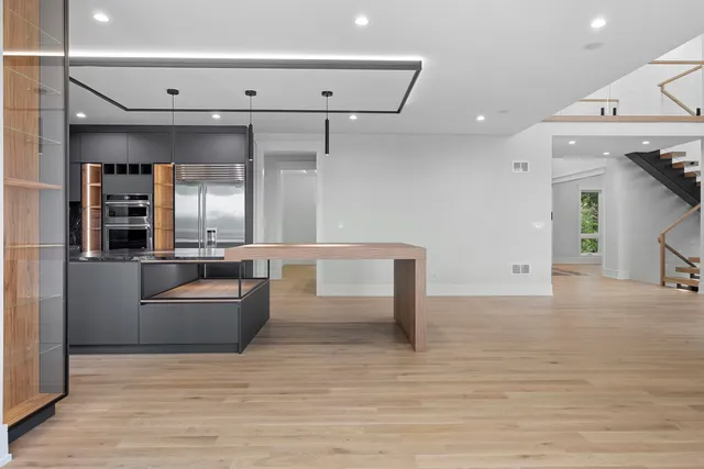 a kitchen with stainless steel appliances kitchen island a refrigerator and a stove top oven