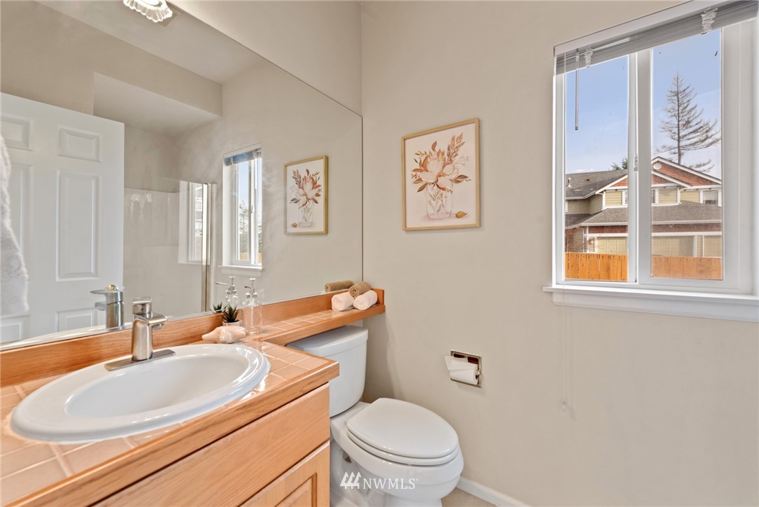 17567 Southeast 186th Way Renton, WA 98058 - Photo 12 of 28 a bathroom with a toilet a sink and a large mirror