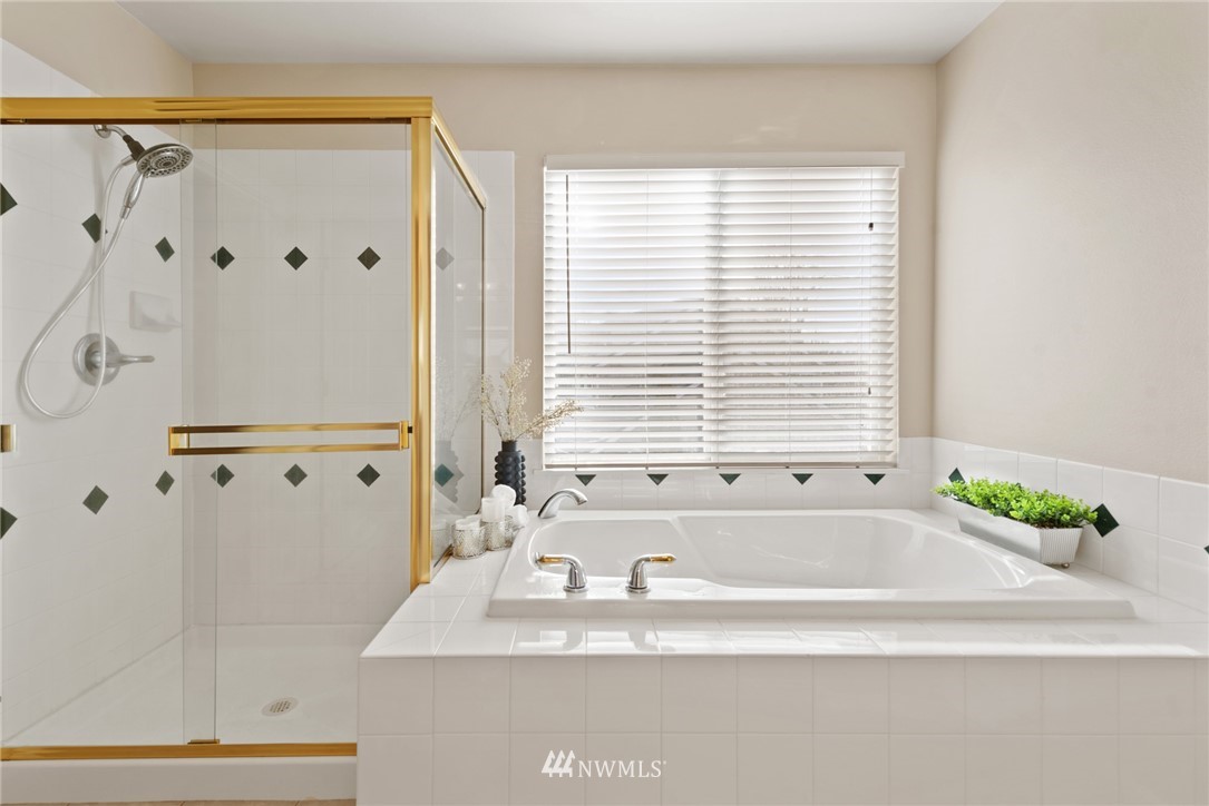 17567 Southeast 186th Way Renton, WA 98058 - Photo 17 of 28 a bathroom with a granite countertop tub a sink and a window