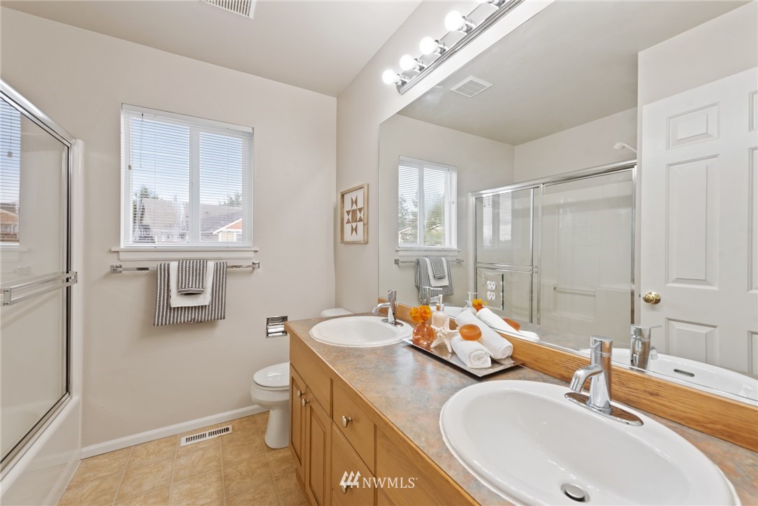 17567 Southeast 186th Way Renton, WA 98058 - Photo 23 of 28 a bathroom with a double vanity sink mirror and a toilet