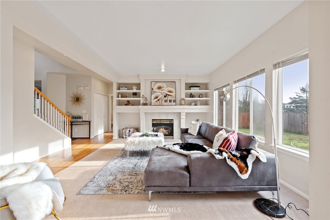 17567 Southeast 186th Way Renton, WA 98058 - Photo 3 of 28 a living room with furniture large window and a fireplace