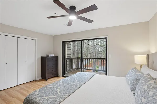 a bedroom with a large bed and a chandelier