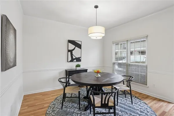a view of a dining room with furniture wooden floor and a chandelier
