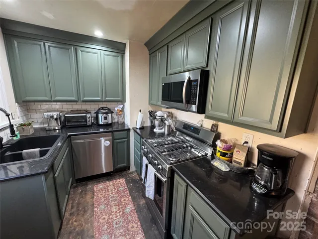 a kitchen with a sink stove and refrigerator