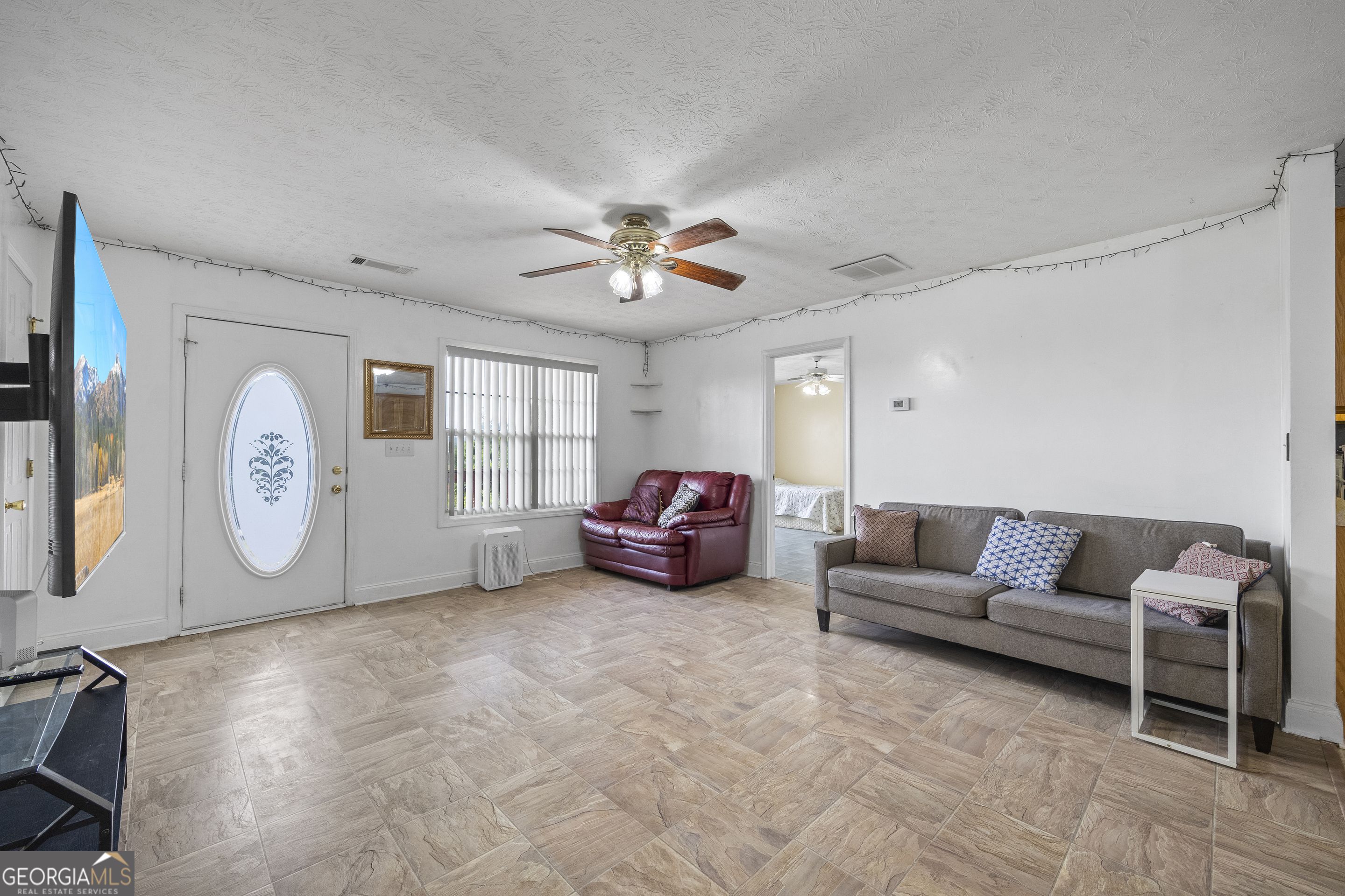 574 Mt Bethel Road Commerce, GA 30530 - Photo 23 of 64 a living room with furniture a ceiling fan and a rug