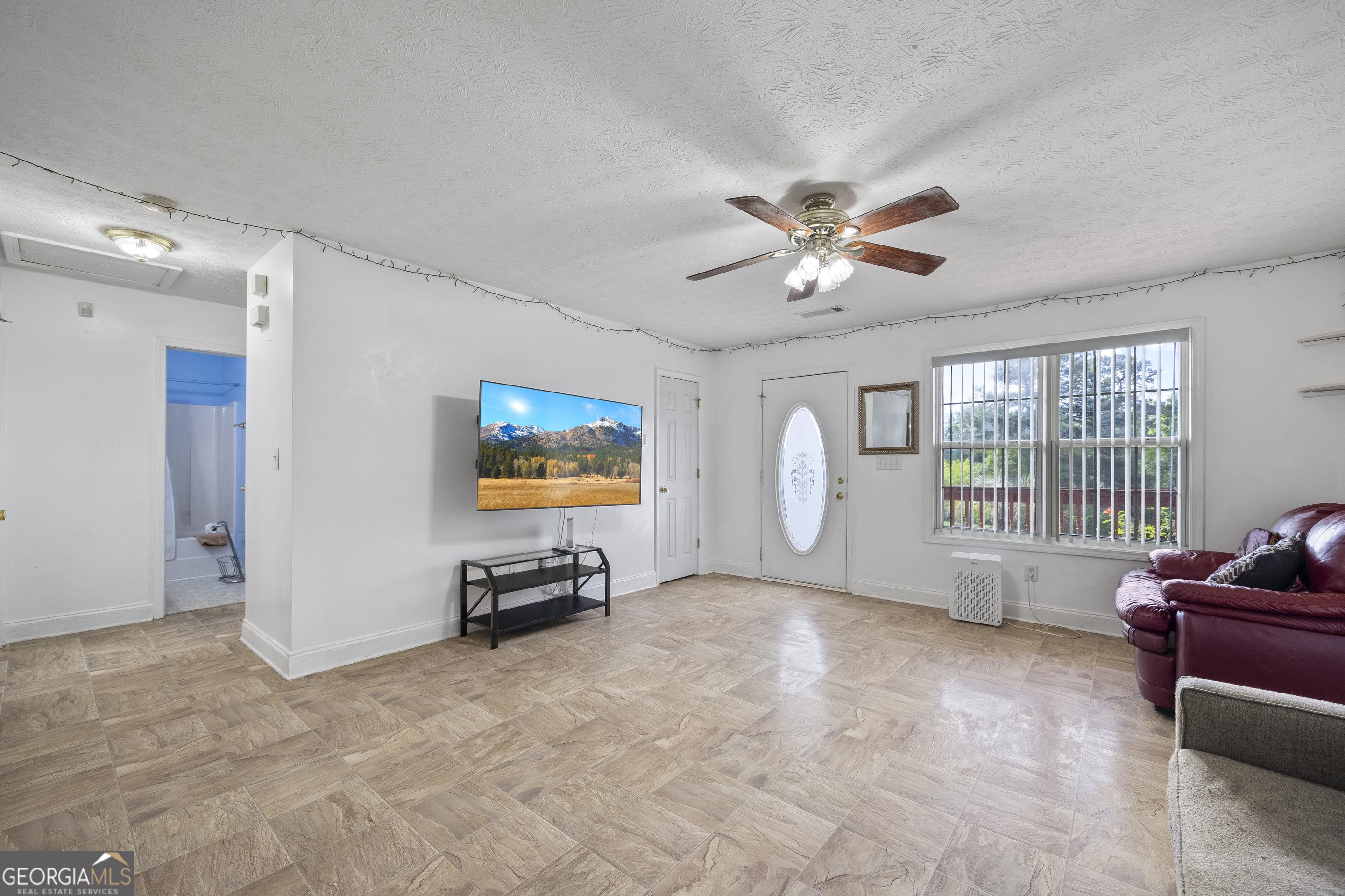 574 Mt Bethel Road Commerce, GA 30530 - Photo 24 of 64 a view of a livingroom with furniture and a ceiling fan