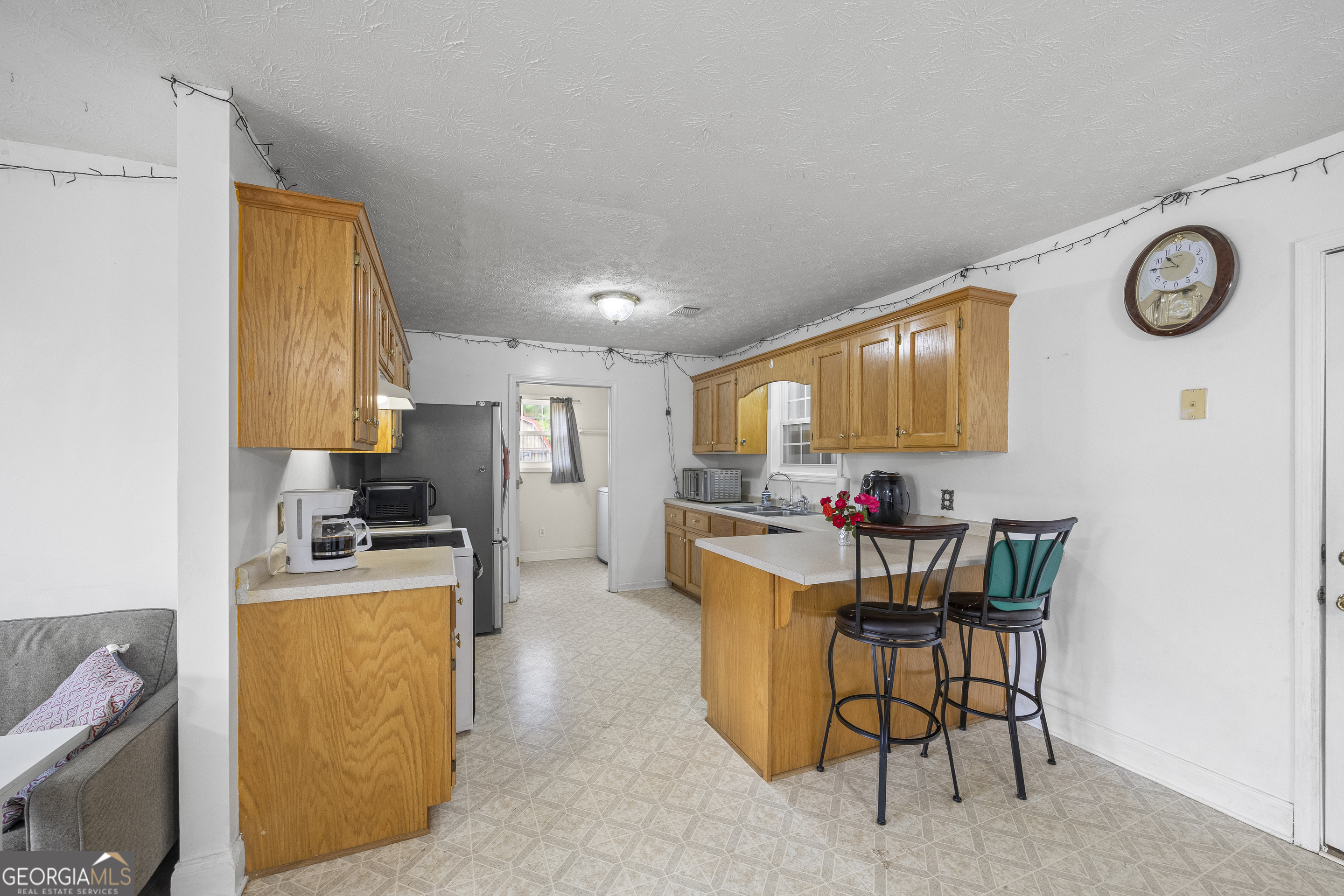574 Mt Bethel Road Commerce, GA 30530 - Photo 27 of 64 a view of a kitchen with dining area and a refrigerator