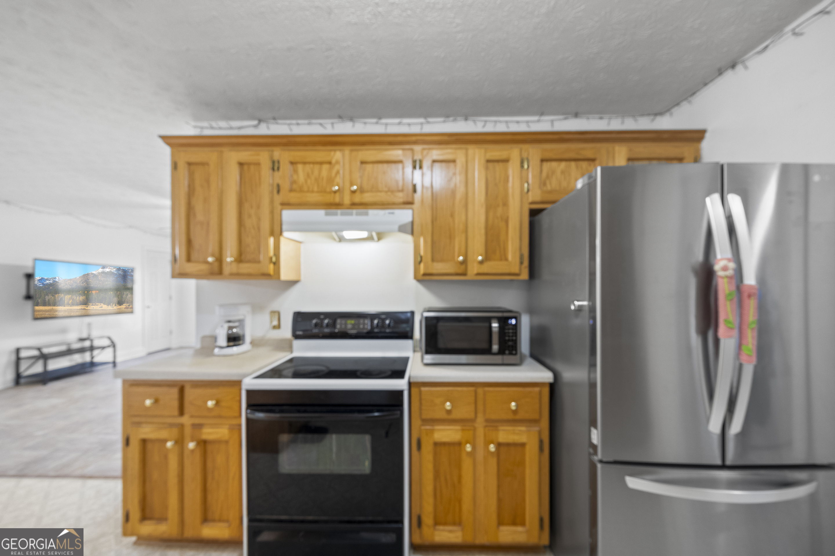 574 Mt Bethel Road Commerce, GA 30530 - Photo 31 of 64 a kitchen with stainless steel appliances a refrigerator and a stove top oven