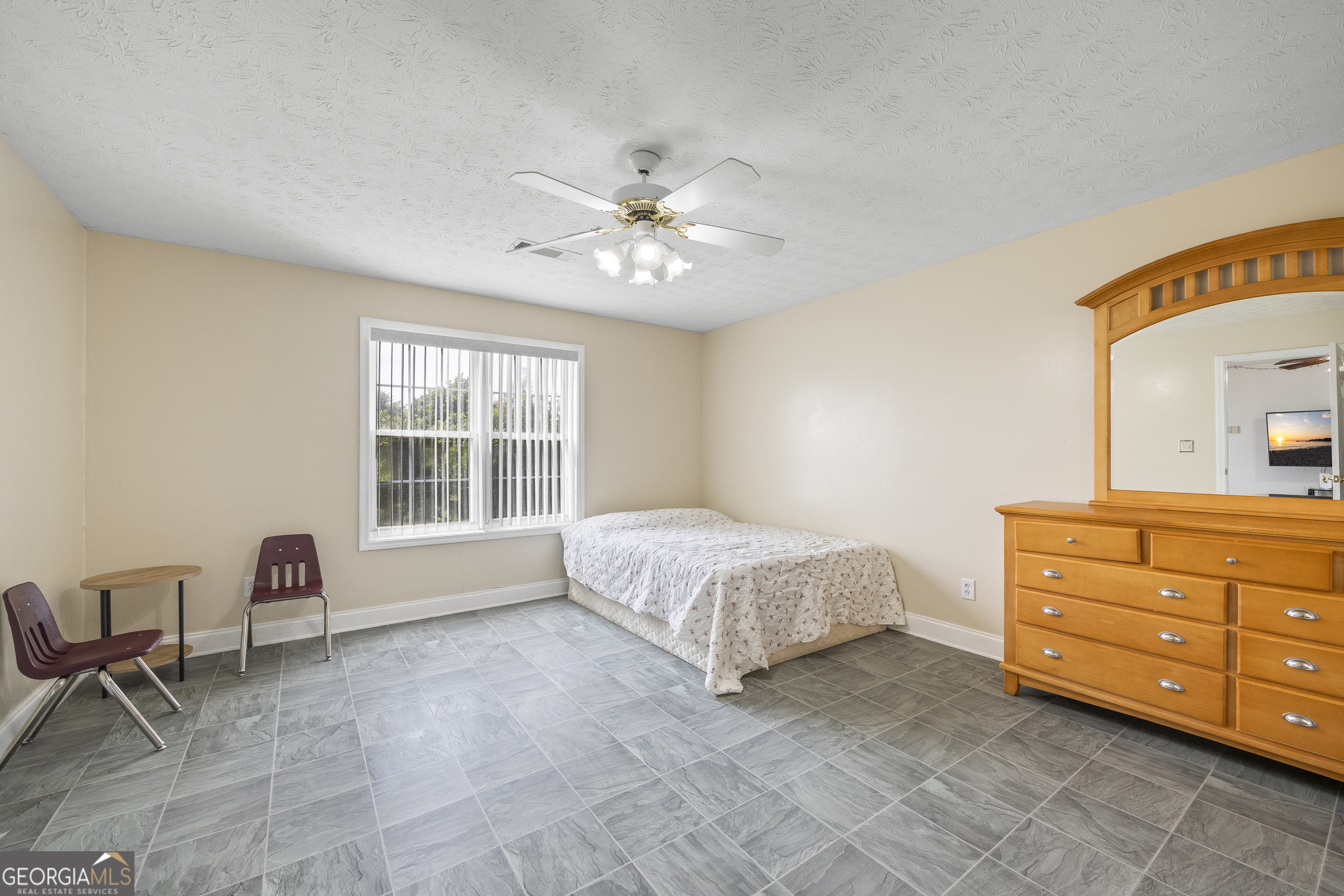 574 Mt Bethel Road Commerce, GA 30530 - Photo 40 of 64 a spacious bedroom with a bed and chair