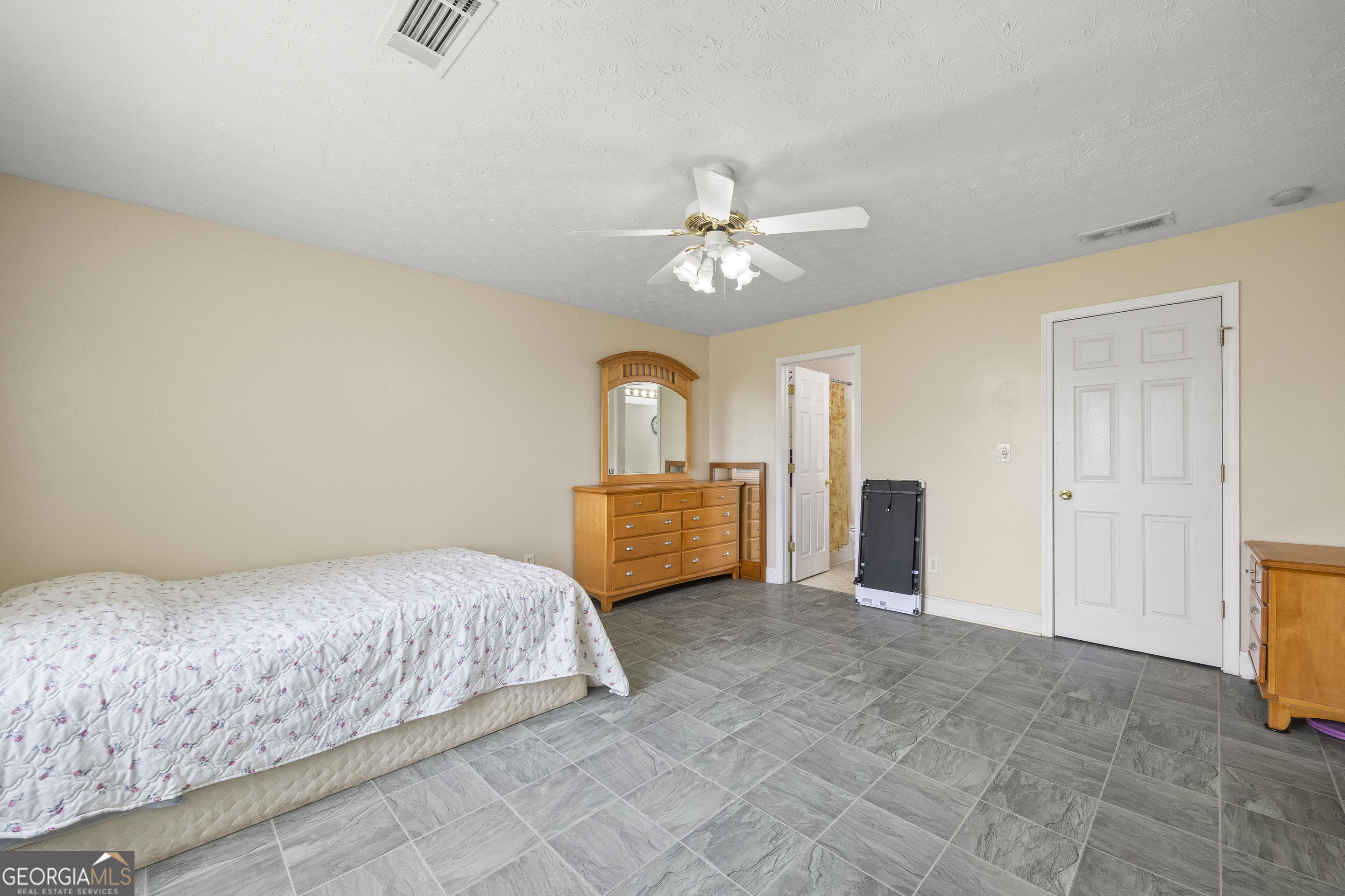 574 Mt Bethel Road Commerce, GA 30530 - Photo 42 of 64 a bedroom with a bed and a chandelier
