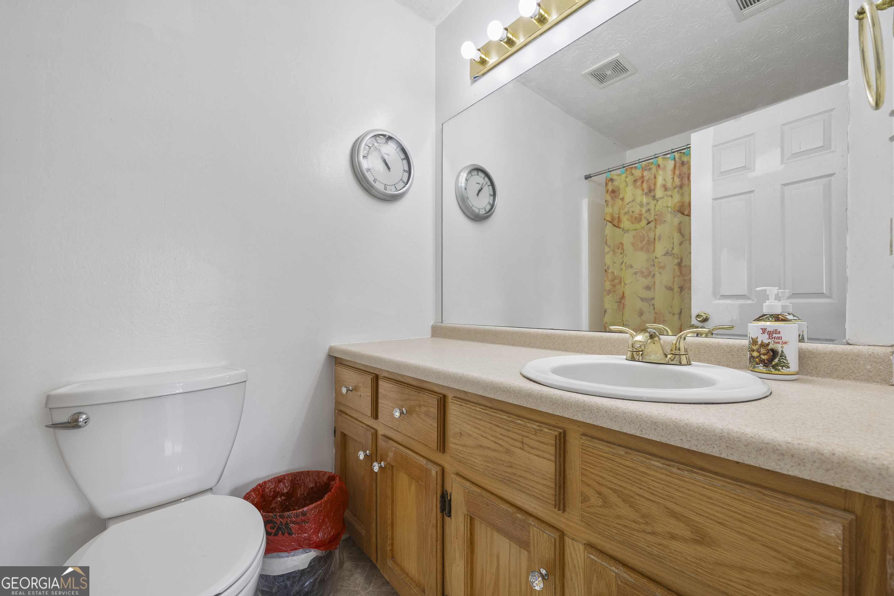 574 Mt Bethel Road Commerce, GA 30530 - Photo 43 of 64 a bathroom with a granite countertop toilet sink and mirror