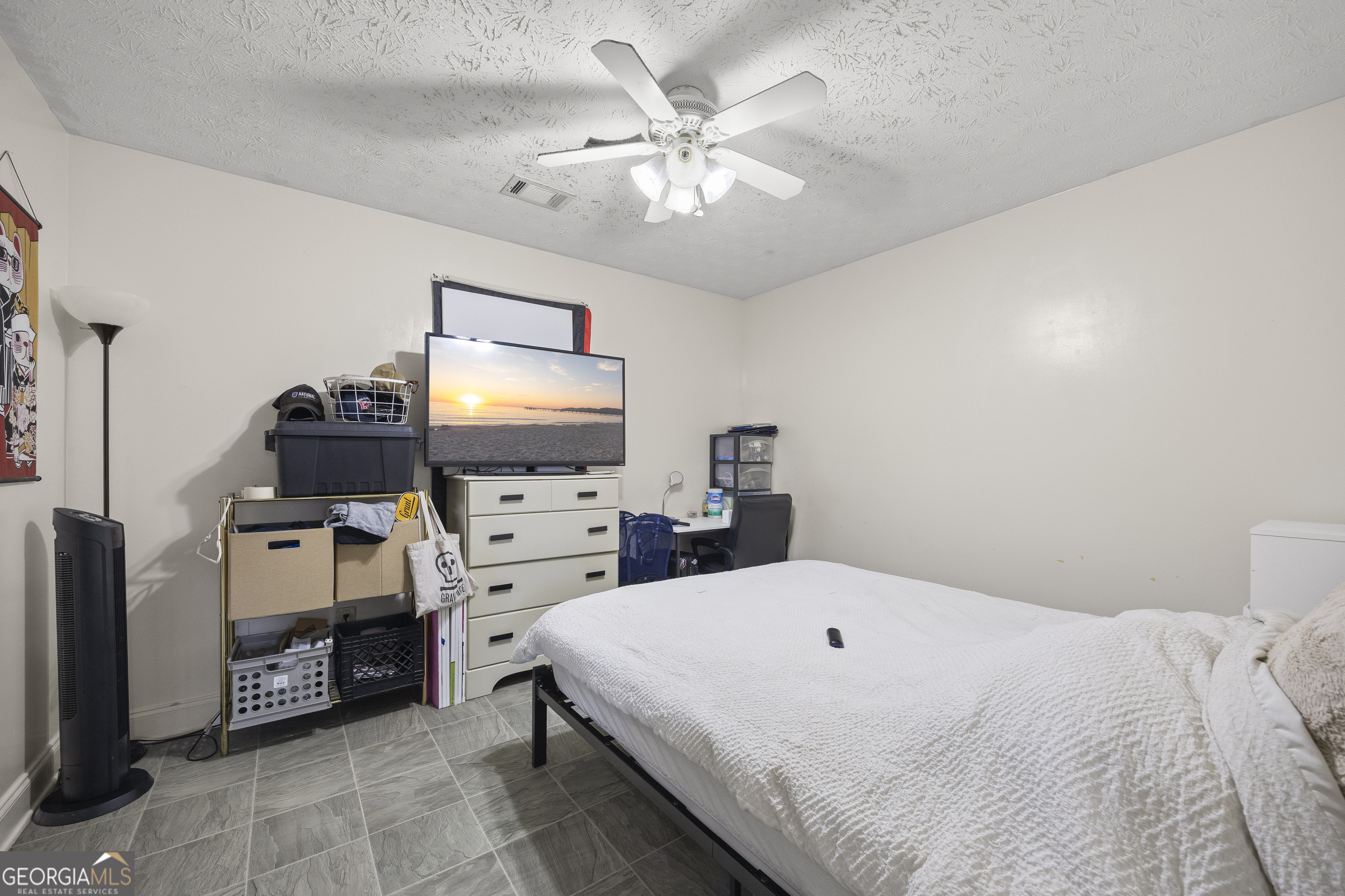 574 Mt Bethel Road Commerce, GA 30530 - Photo 45 of 64 a bedroom with a bed and a flat screen tv