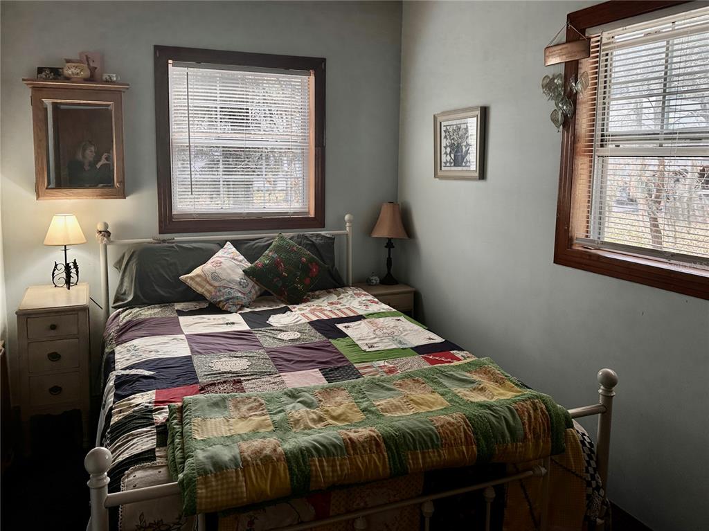 2807 Tindel Camp Road Lake Wales, FL 33898 - Photo 13 of 32 a bedroom with a bed and wooden floor