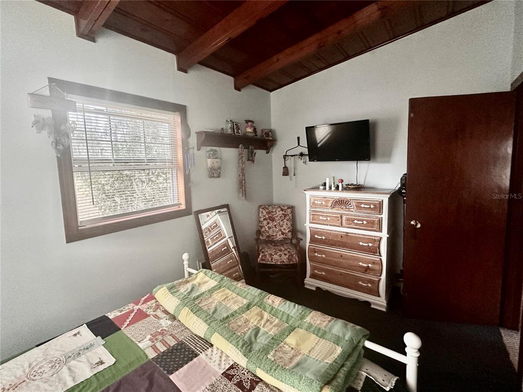 2807 Tindel Camp Road Lake Wales, FL 33898 - Photo 16 of 32 a bed room with a bed a television and a window