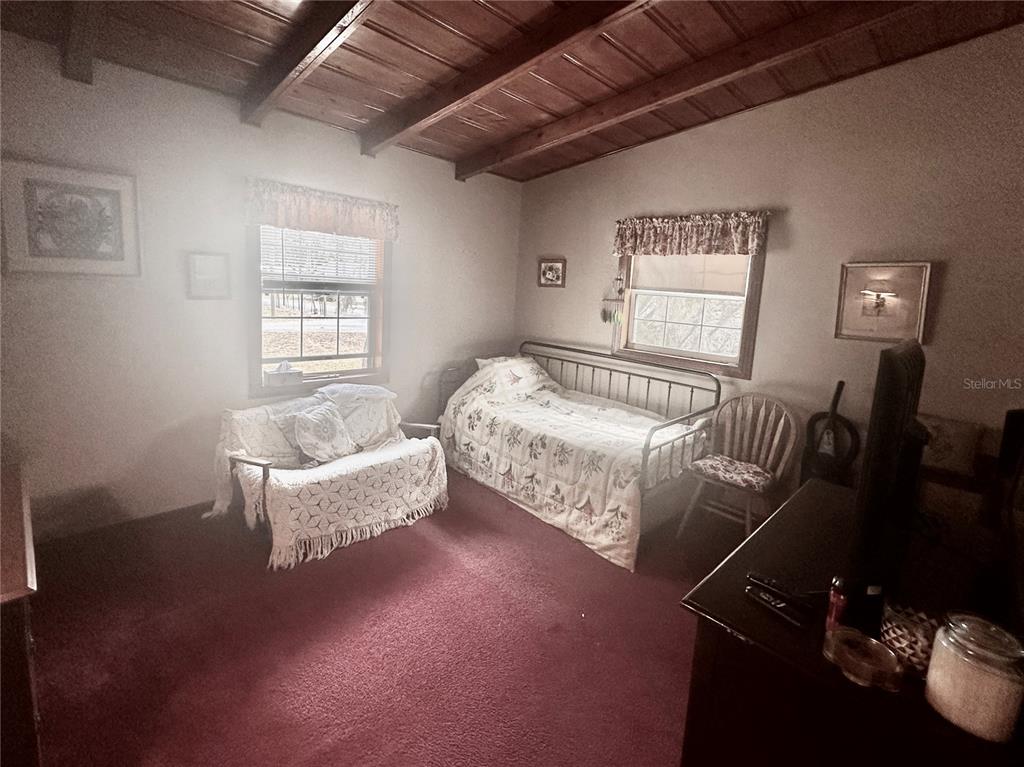 2807 Tindel Camp Road Lake Wales, FL 33898 - Photo 17 of 32 a bedroom with bed couch and window