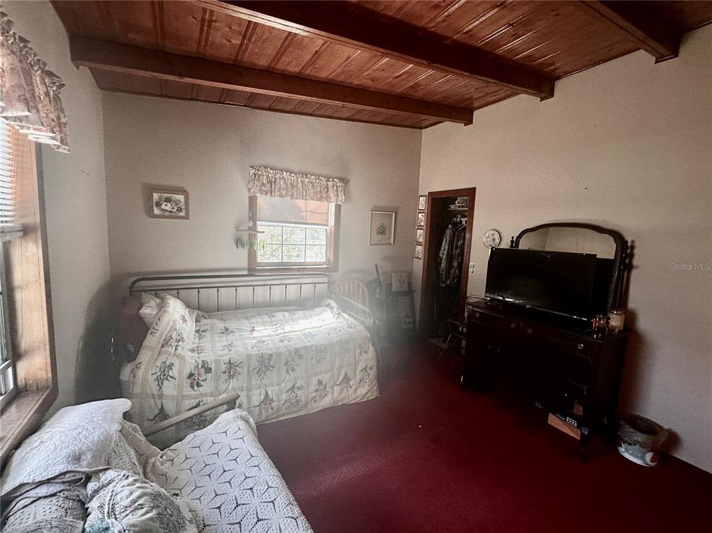 2807 Tindel Camp Road Lake Wales, FL 33898 - Photo 20 of 32 a bedroom with a bed and wooden floor