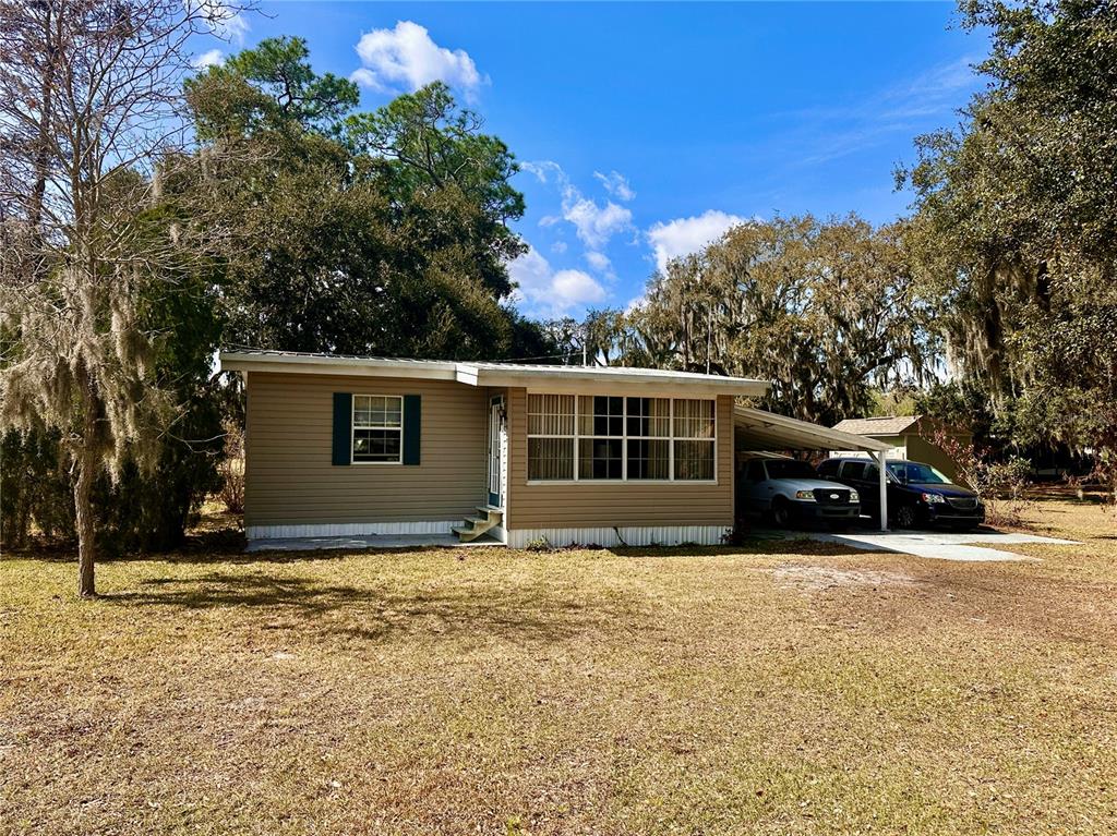 2807 Tindel Camp Road Lake Wales, FL 33898 - Photo 29 of 32 a front view of house with yard and trees in the background