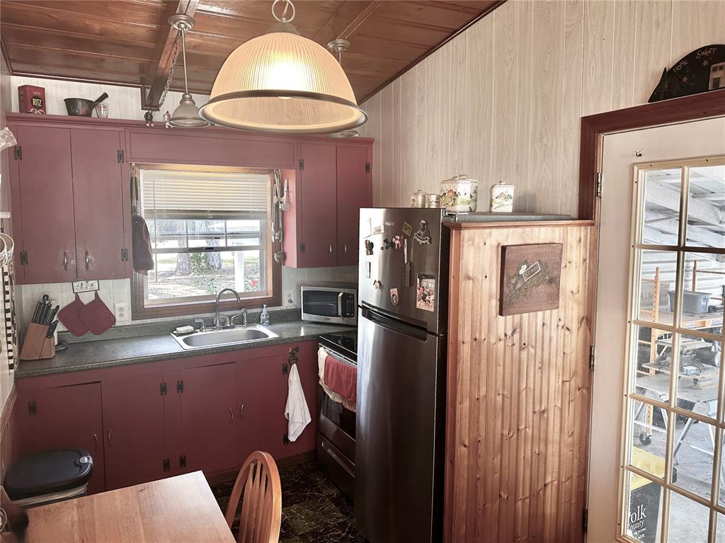 2807 Tindel Camp Road Lake Wales, FL 33898 - Photo 4 of 32 a kitchen with stainless steel appliances granite countertop a refrigerator sink and cabinets
