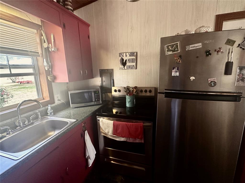 2807 Tindel Camp Road Lake Wales, FL 33898 - Photo 9 of 32 a kitchen with a refrigerator and a sink