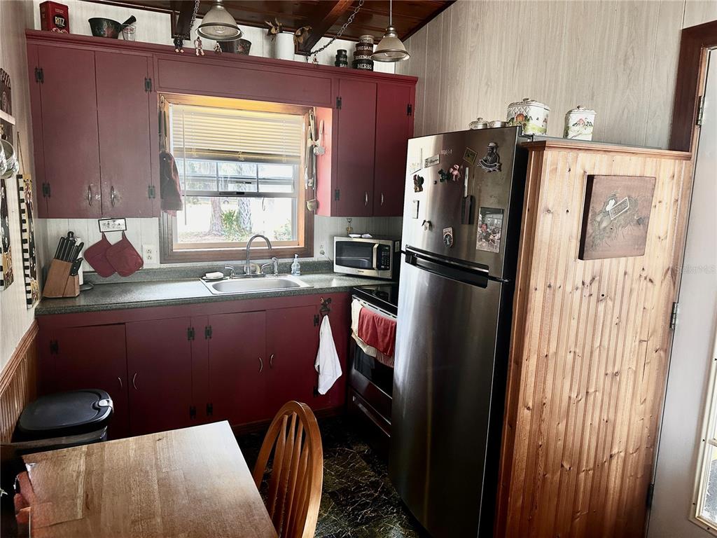 2807 Tindel Camp Road Lake Wales, FL 33898 - Photo 10 of 32 a kitchen with stainless steel appliances granite countertop a refrigerator a sink a stove and a refrigerator