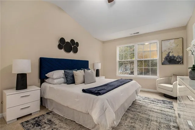 a bedroom with a large bed and a window