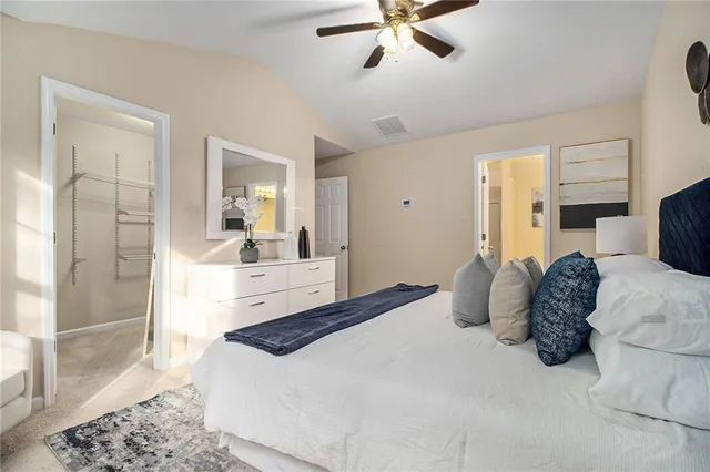 a bedroom with a large bed and a chandelier