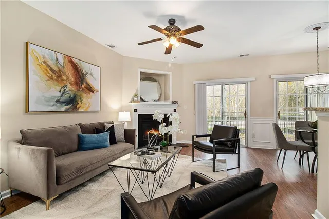 a living room with furniture a fireplace and a view of kitchen