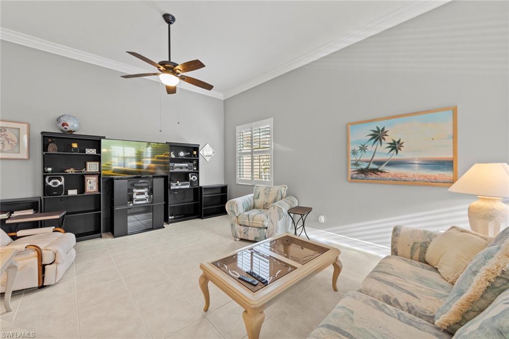 9057 Whitfield Drive Estero, FL 33928 - Photo 11 of 32 a living room with furniture a rug and a ceiling fan
