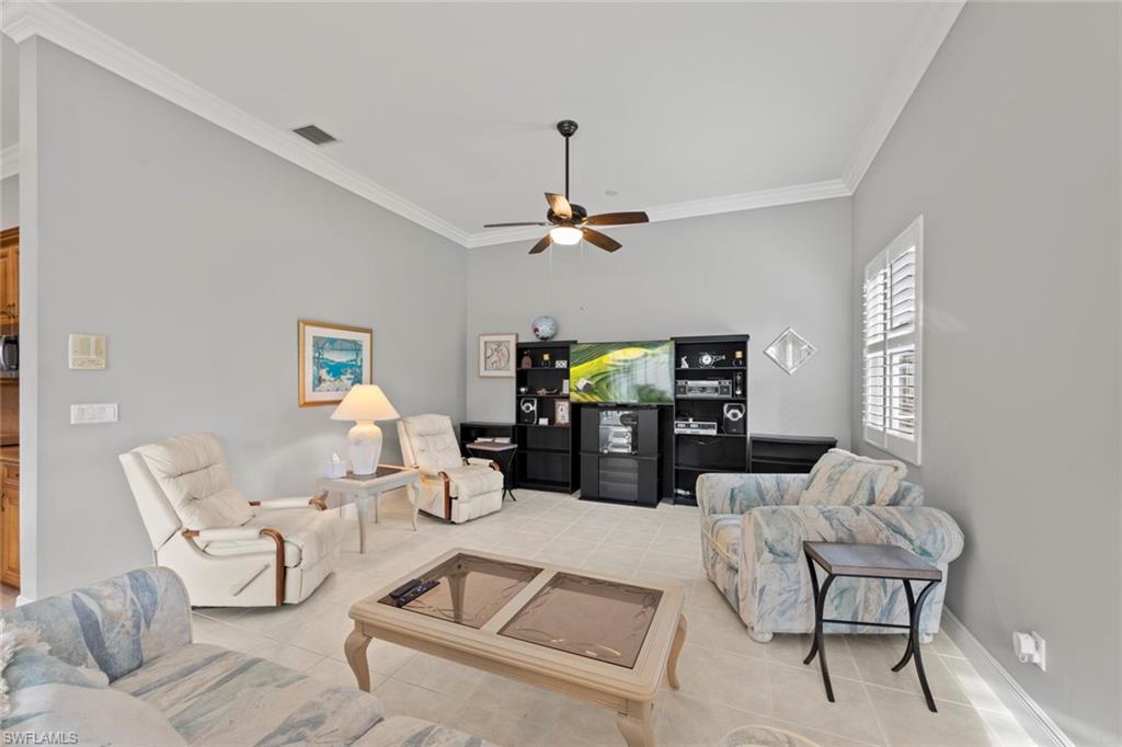 9057 Whitfield Drive Estero, FL 33928 - Photo 12 of 32 a living room with furniture and a chandelier