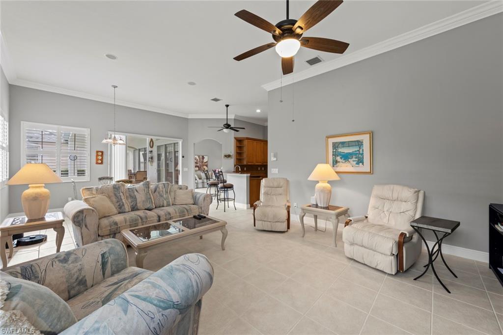 9057 Whitfield Drive Estero, FL 33928 - Photo 13 of 32 a living room with furniture and a flat screen tv