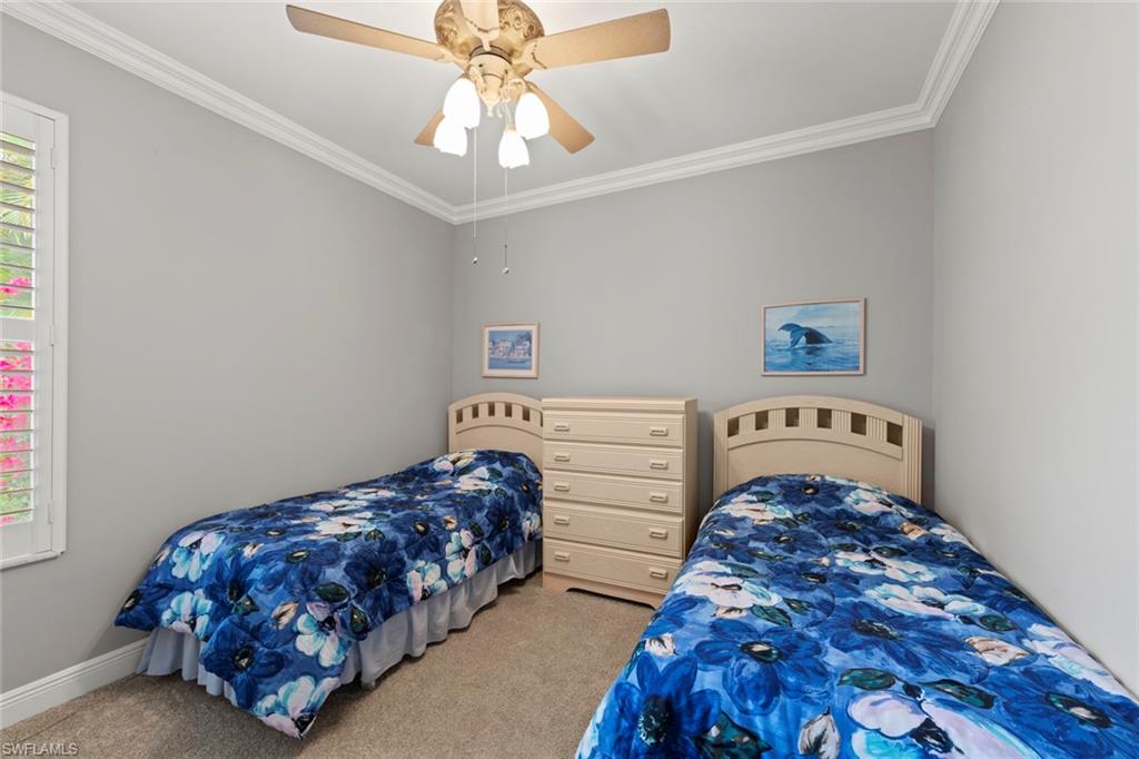 9057 Whitfield Drive Estero, FL 33928 - Photo 20 of 32 a bedroom with bed and window