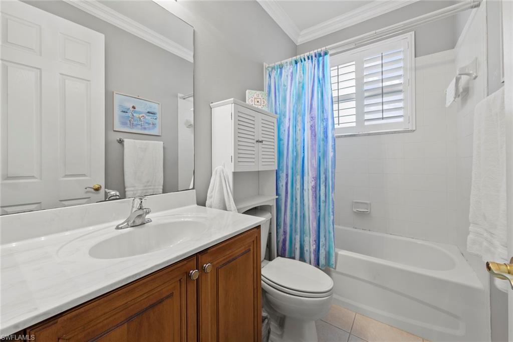 9057 Whitfield Drive Estero, FL 33928 - Photo 21 of 32 a bathroom with a sink a toilet and shower