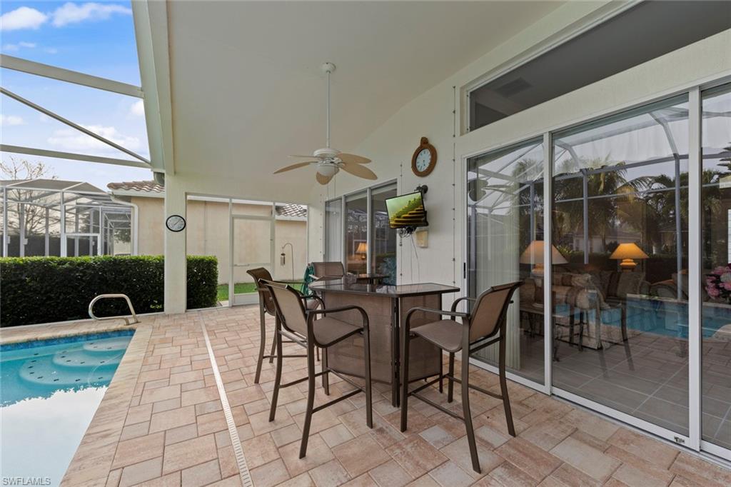 9057 Whitfield Drive Estero, FL 33928 - Photo 27 of 32 a view of a patio with table and chairs