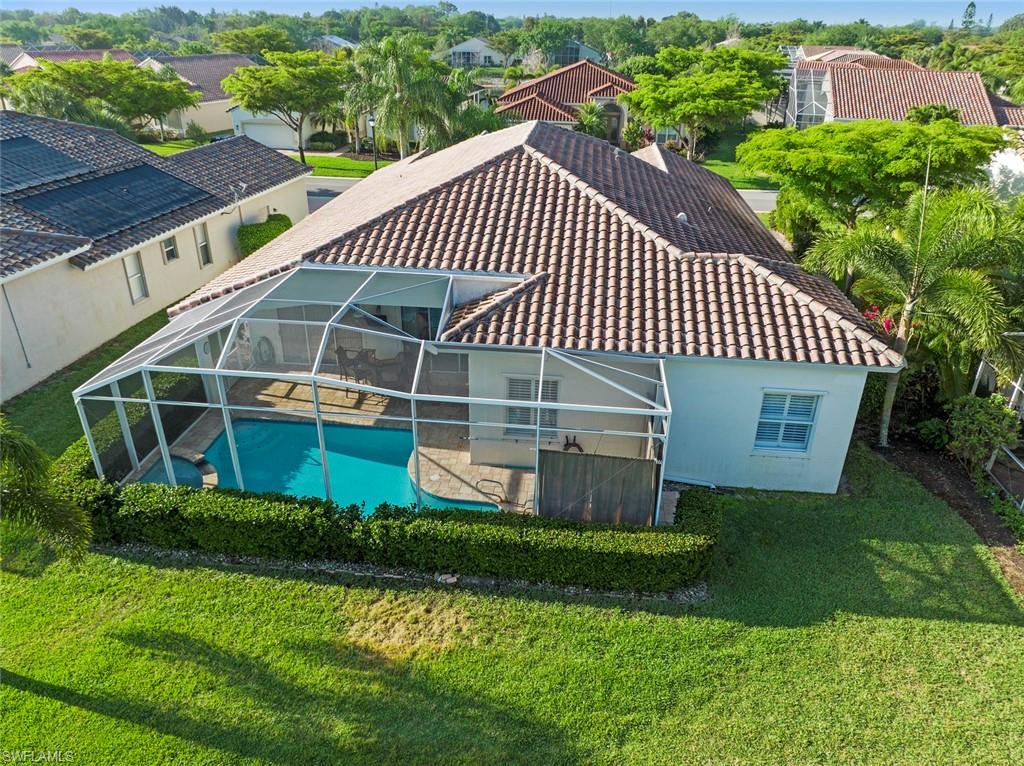 9057 Whitfield Drive Estero, FL 33928 - Photo 28 of 32 a view of a house with a yard