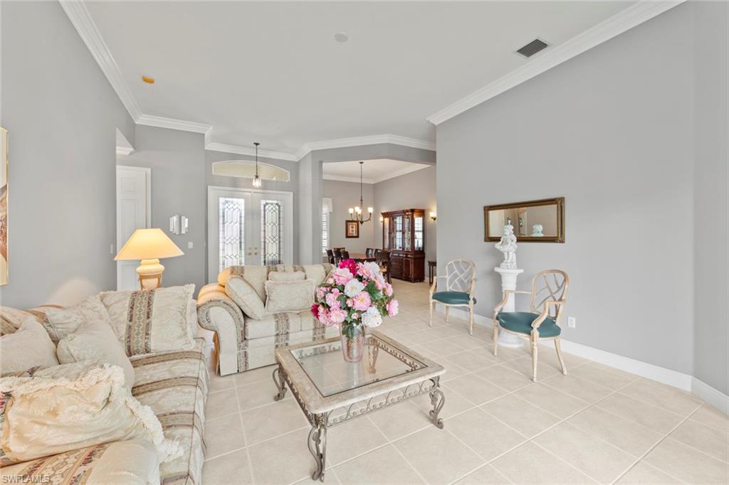 9057 Whitfield Drive Estero, FL 33928 - Photo 3 of 32 a living room with furniture and a table
