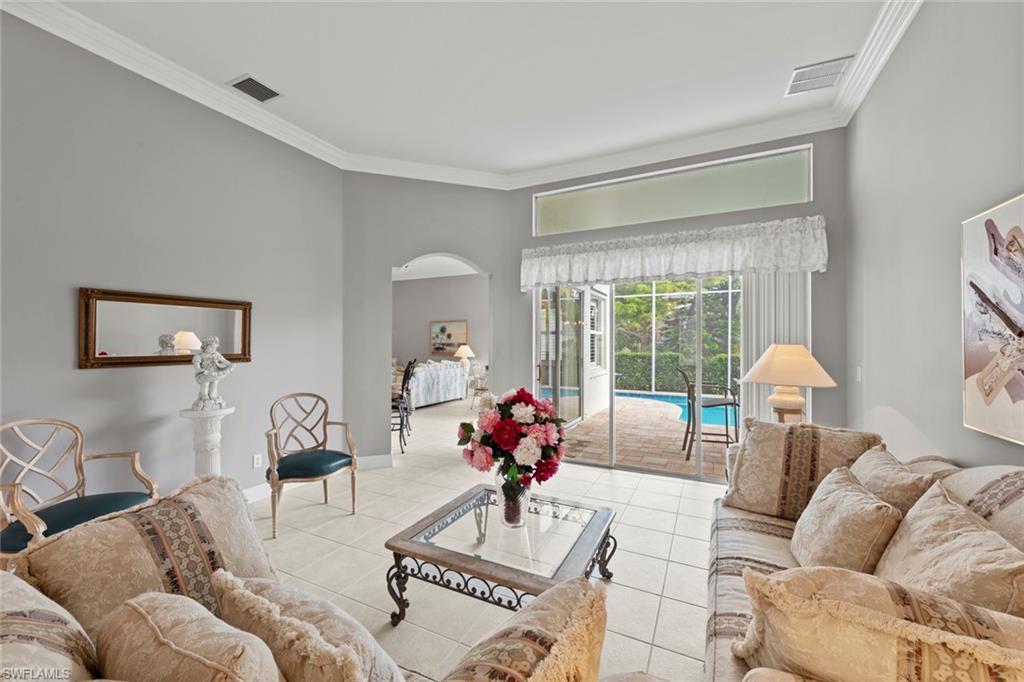 9057 Whitfield Drive Estero, FL 33928 - Photo 4 of 32 a living room with furniture and a large window
